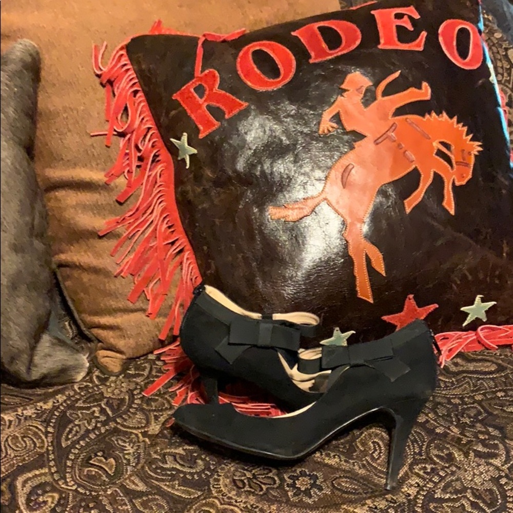 Nine west heels with zipper and bow accent.